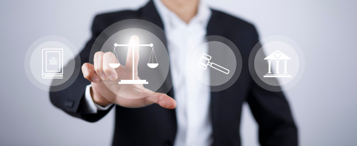 An individual dressed in a suit presents a virtual justice icon, representing the intersection of law and technology.