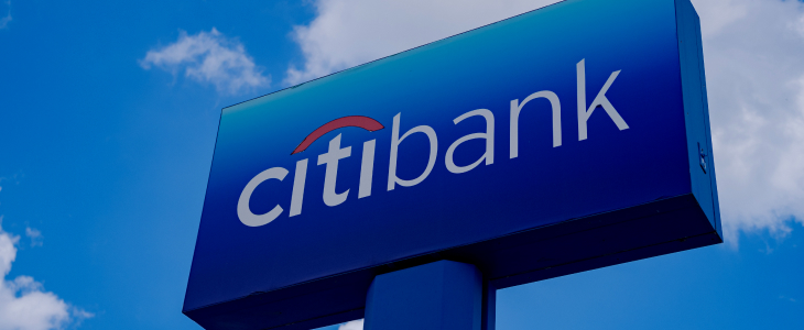 A Citi Bank sign set against a bright blue sky, representing the bank's presence and commitment to customer service.