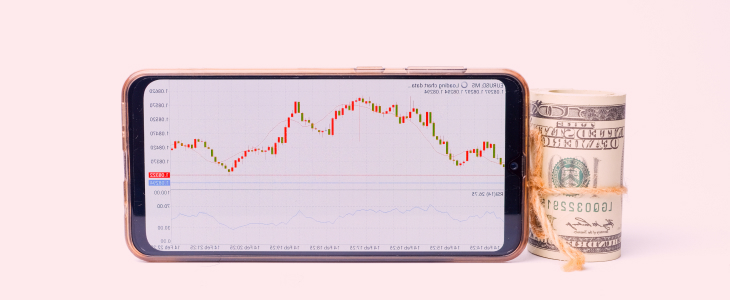 A collection of dollar bills alongside a stock chart, set against a vibrant pink background.