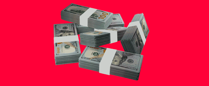 A collection of banknotes arranged on a striking red backdrop, representing financial abundance.