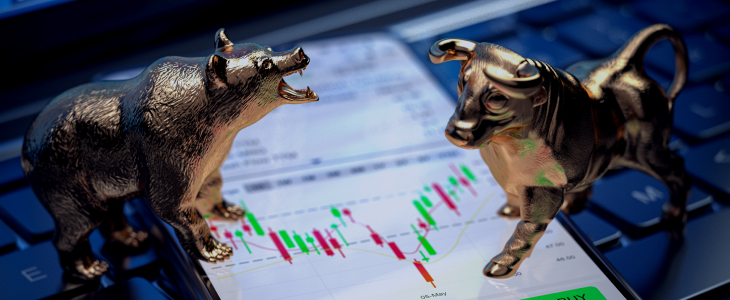 A laptop screen displaying a bull and bear symbolizing stock market trading dynamics.